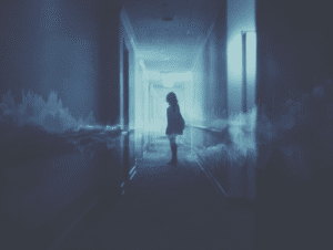 A silhouetted person stands in a dimly lit hallway, illuminated by cool blue tones. Abstract, translucent sound waves stretch horizontally across the scene, blending with mist and adding an ethereal, mysterious atmosphere to the corridor.